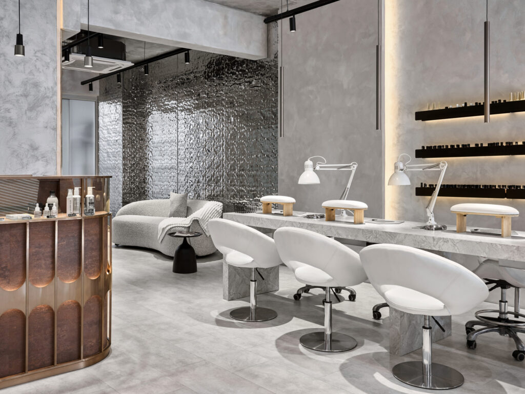 TA Beauty salon with reflective feature wall and manicure stations