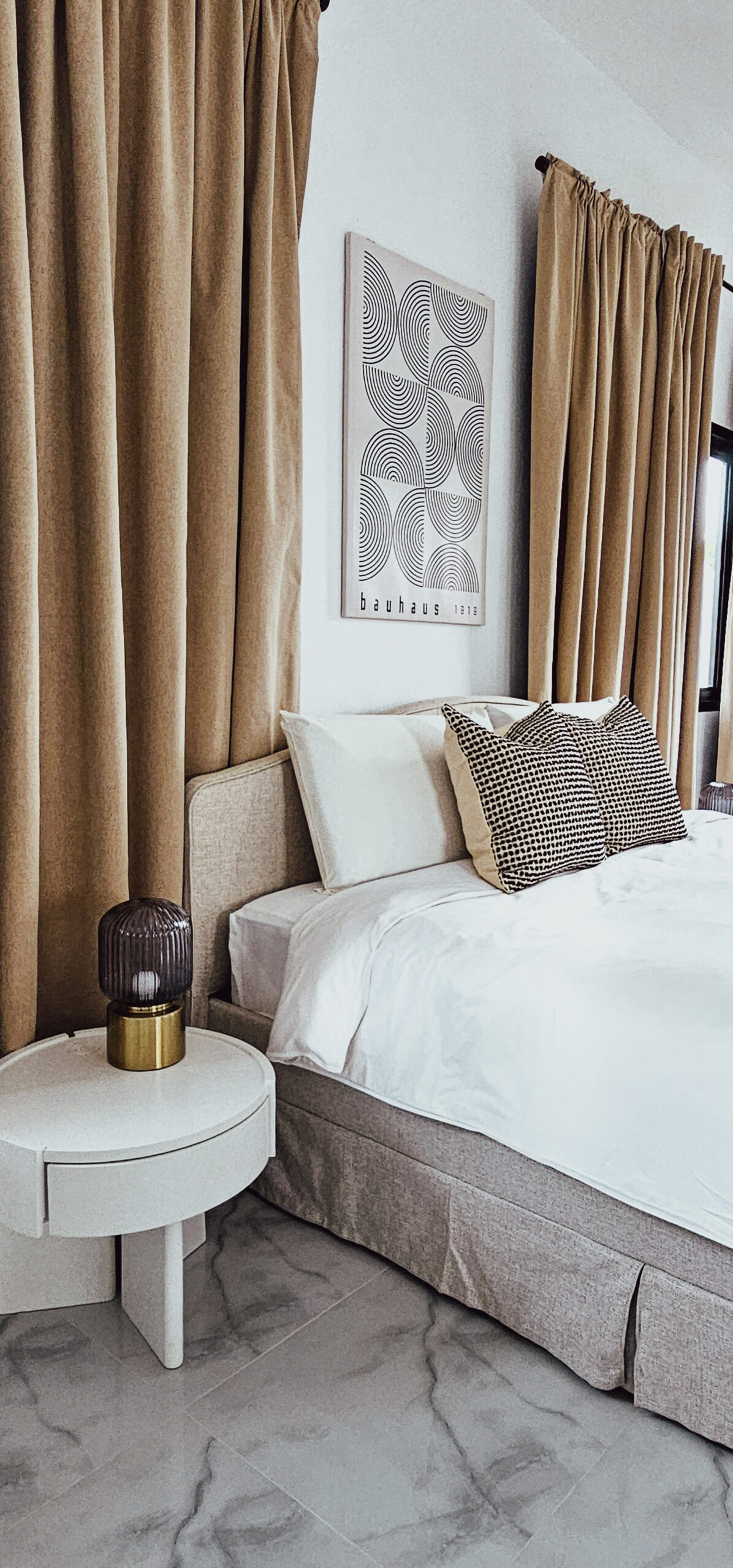NaY Yang Villa bedroom with warm curtains and geometric artwork